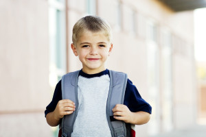 Young child with a backpack, going to school